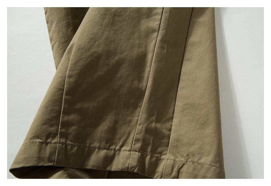 Close-up of khaki trouser leg panels and the stitched hem.