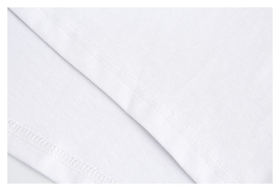 Close-up of white fabric with a diagonal stitched hem and an overlocked edge.