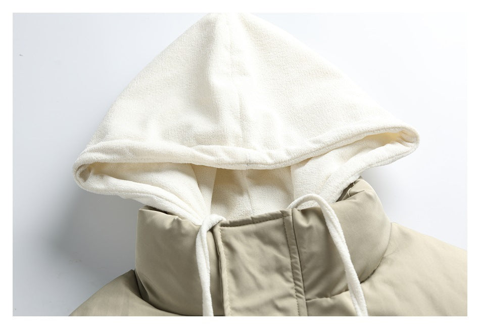 Close-up of a beige padded jacket’s high collar and soft white hood with long white drawstrings.