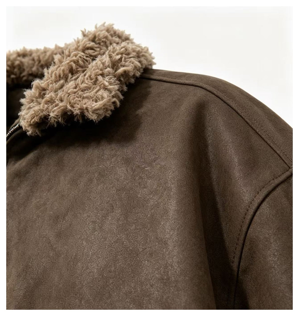 Close-up of a dark brown jacket showing its plush tan collar and shoulder seam.