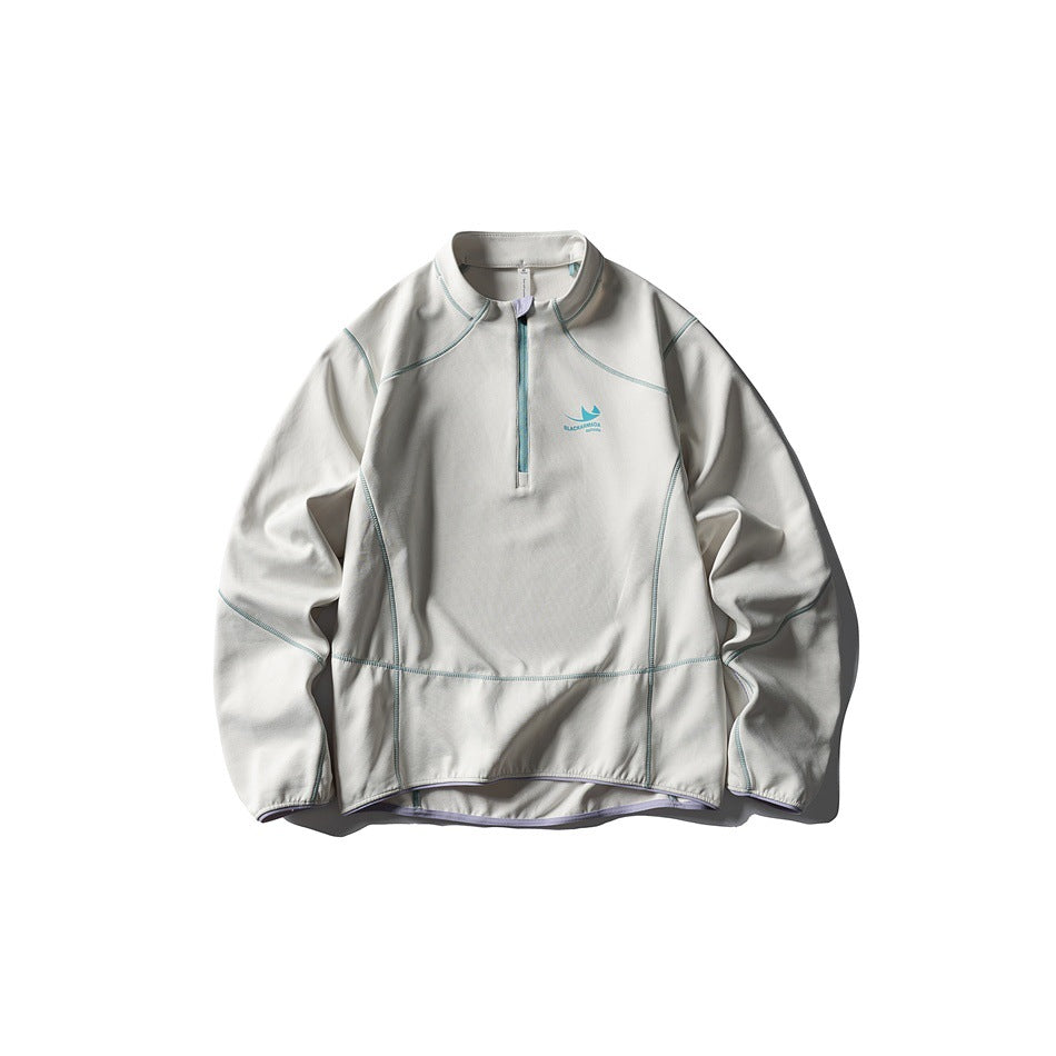 Off-white half-zip pullover flat lay with teal contrast stitching and zipper