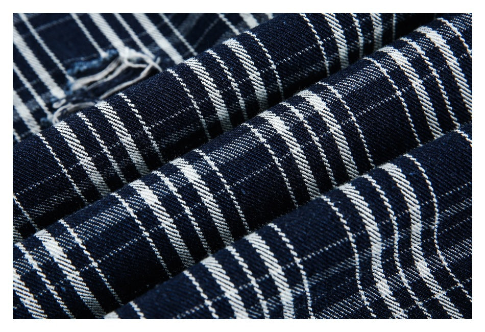 Close-up of folded navy and white plaid fabric showing its woven pattern.