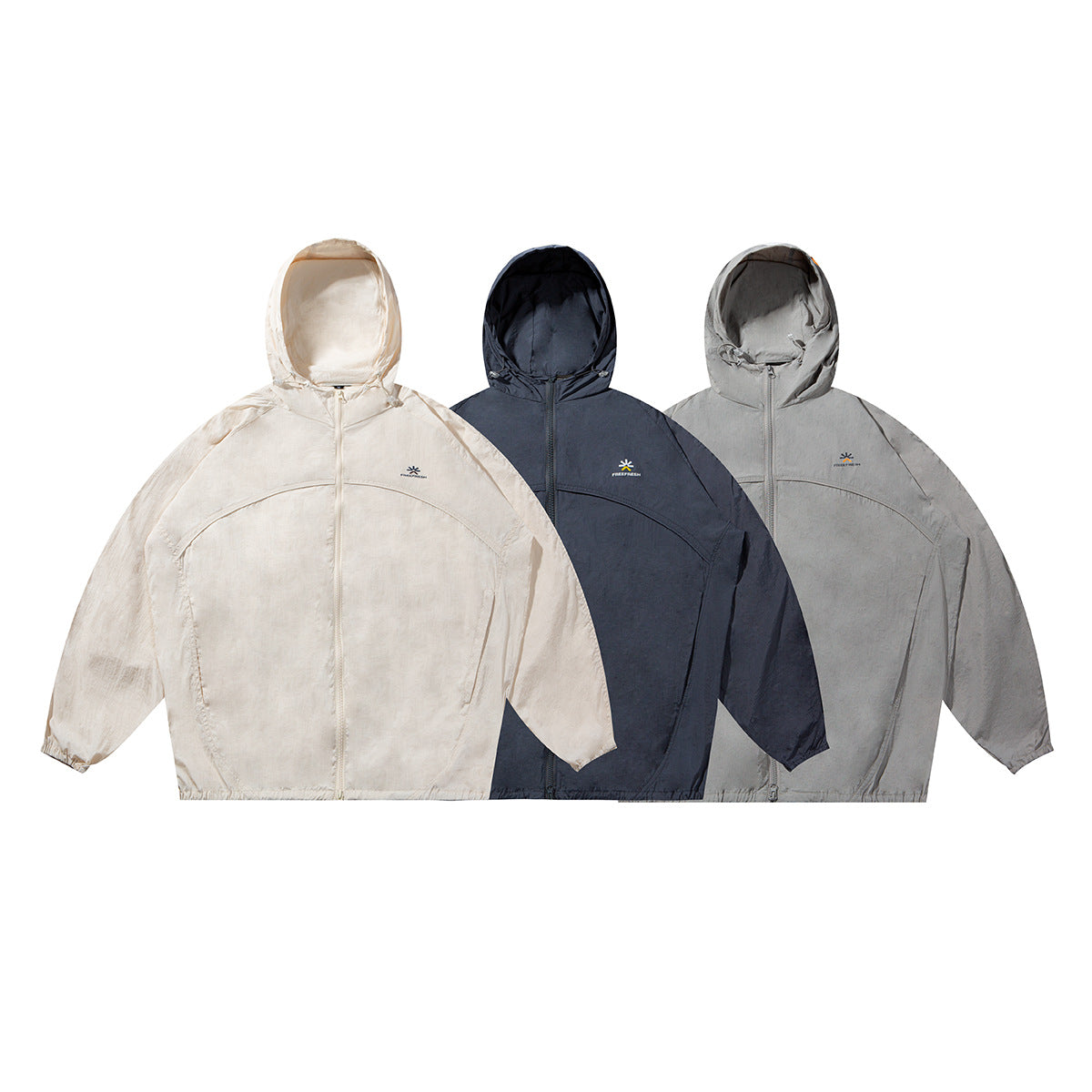 Three hooded zip jackets shown together in cream, dark navy and light gray, each with a small chest logo.