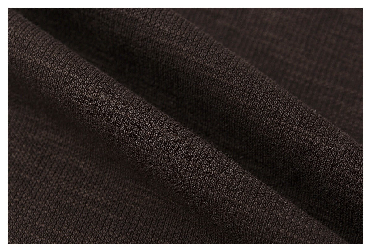 Macro view of the dark brown sweatshirt's textured knit fabric.