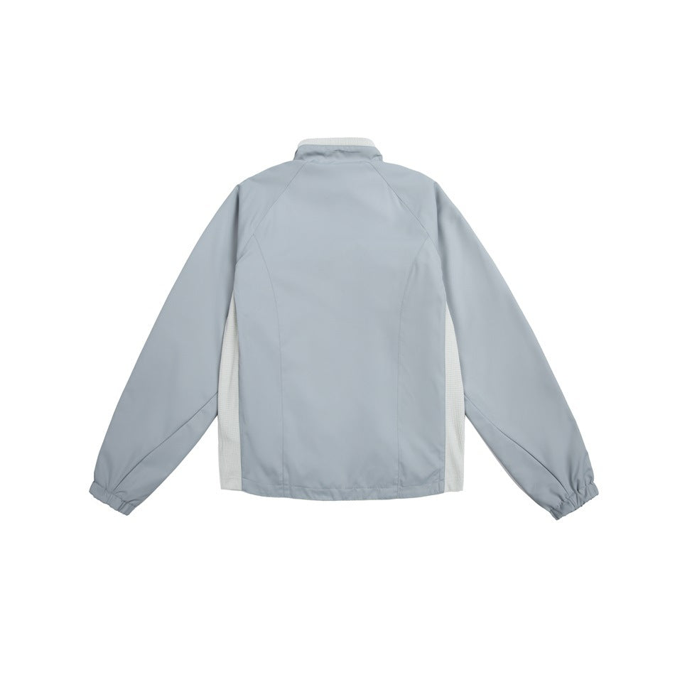 Back view of a light gray jacket with raglan sleeves, elastic cuffs, and pale mesh side panels.