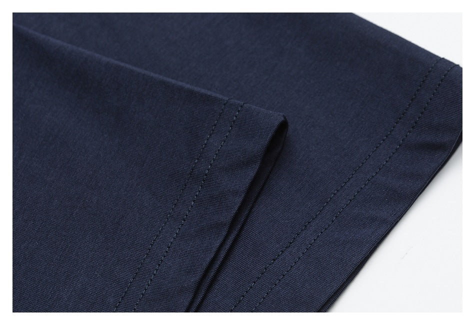 Close-up of a navy garment hem showing its stitched edge and folded seam.