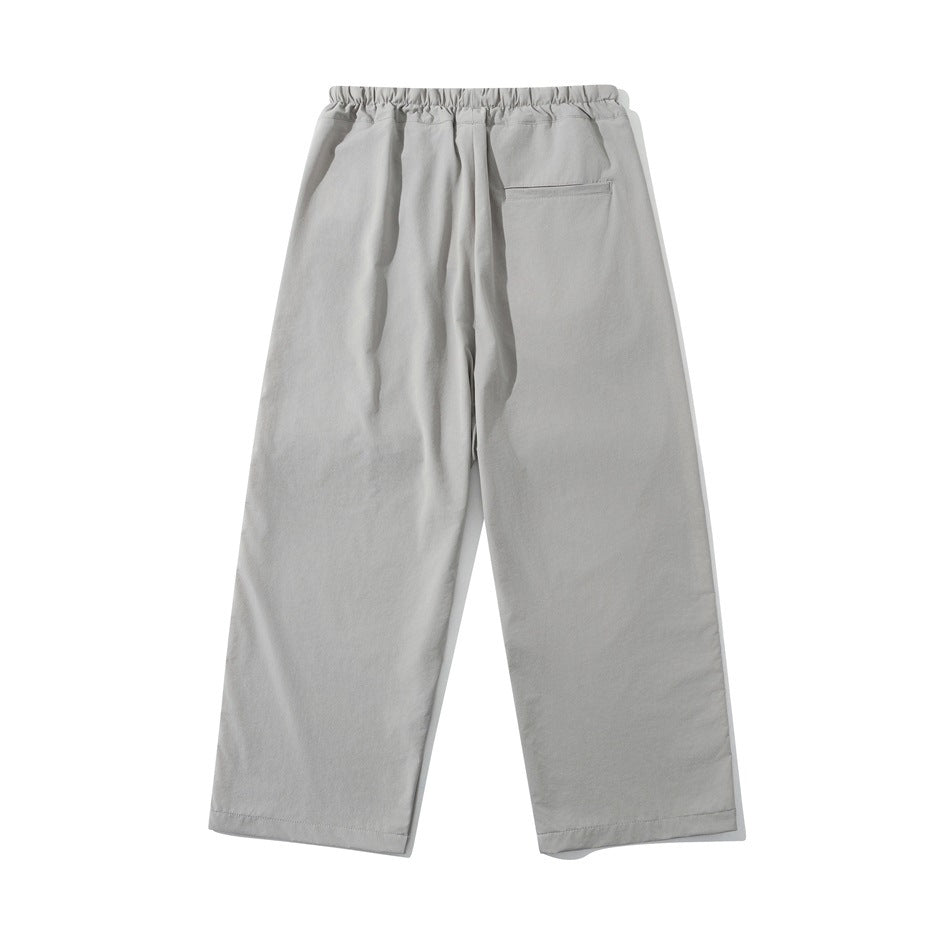 Light gray wide-leg pants, flat back view with elastic waistband and right back welt pocket