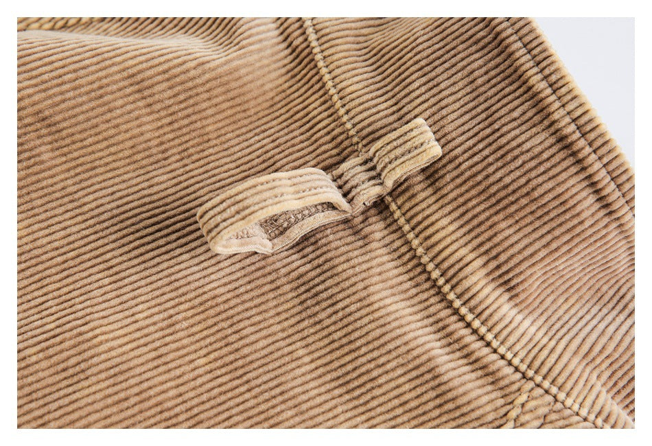 Close-up of a small folded fabric loop stitched onto tan corduroy.