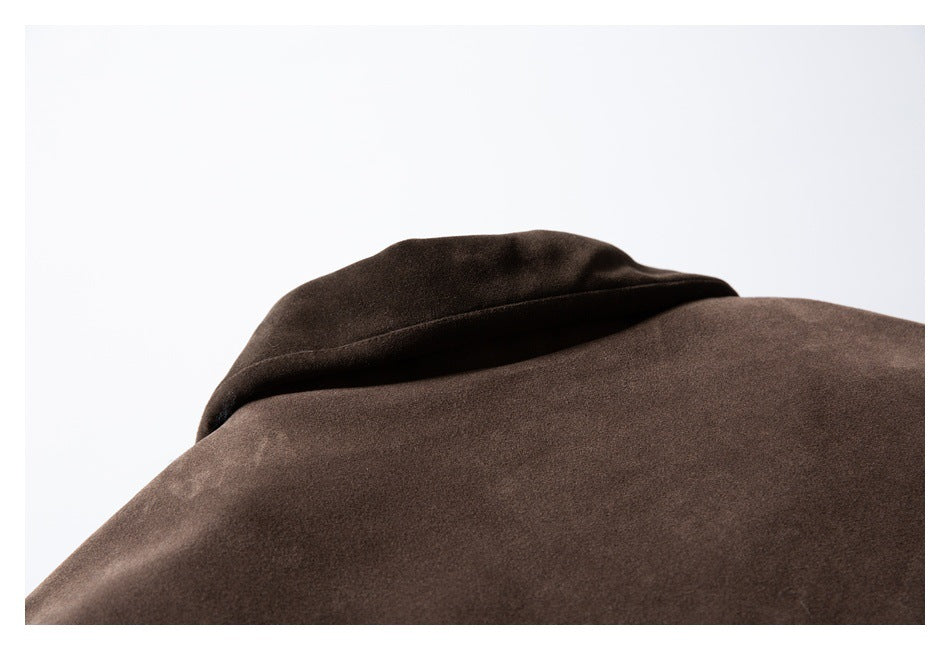 Close-up of a folded collar and shoulder area on a dark brown garment.