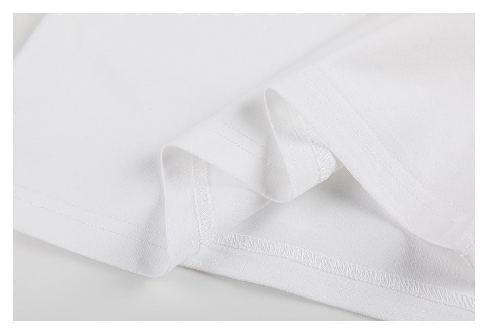 Close-up of the white T-shirt hem showing its stitching and folded edge.