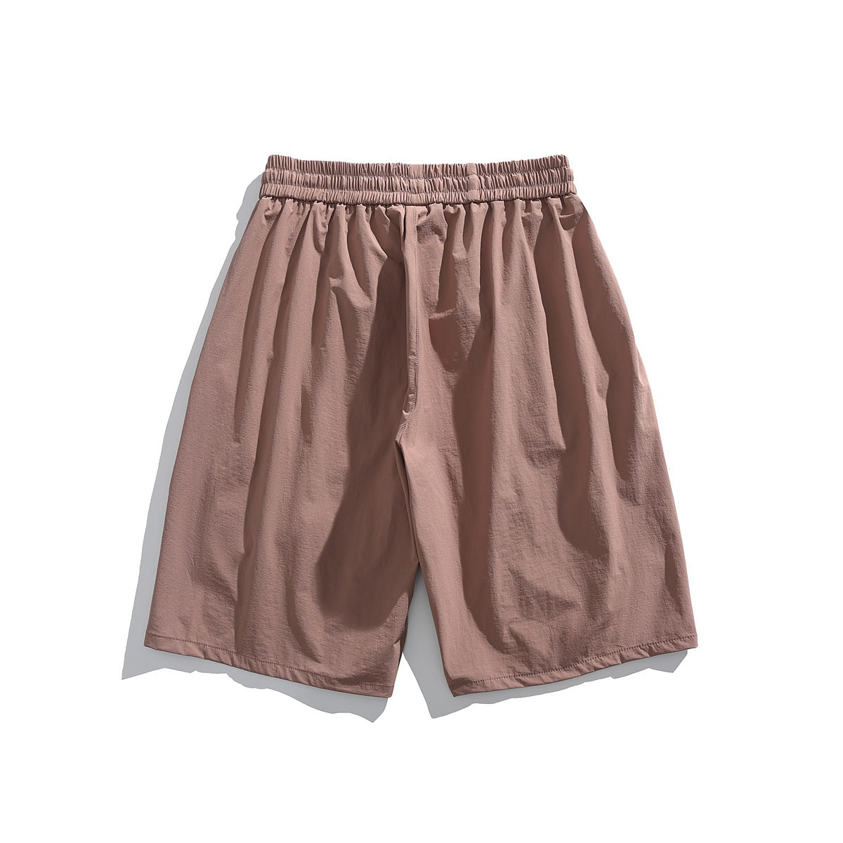 Back view of dusty pink knee-length shorts with elastic waistband and relaxed, loose-fitting legs, flat lay
