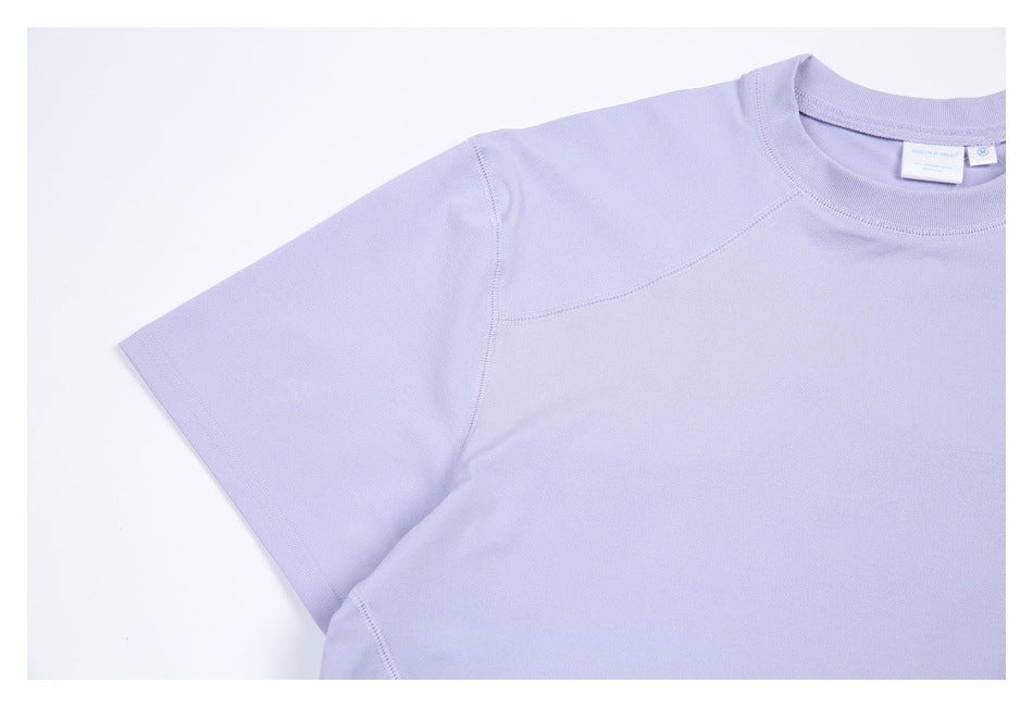 Close-up of the lavender shirt’s short sleeve, curved shoulder seam, and ribbed crew neckline.