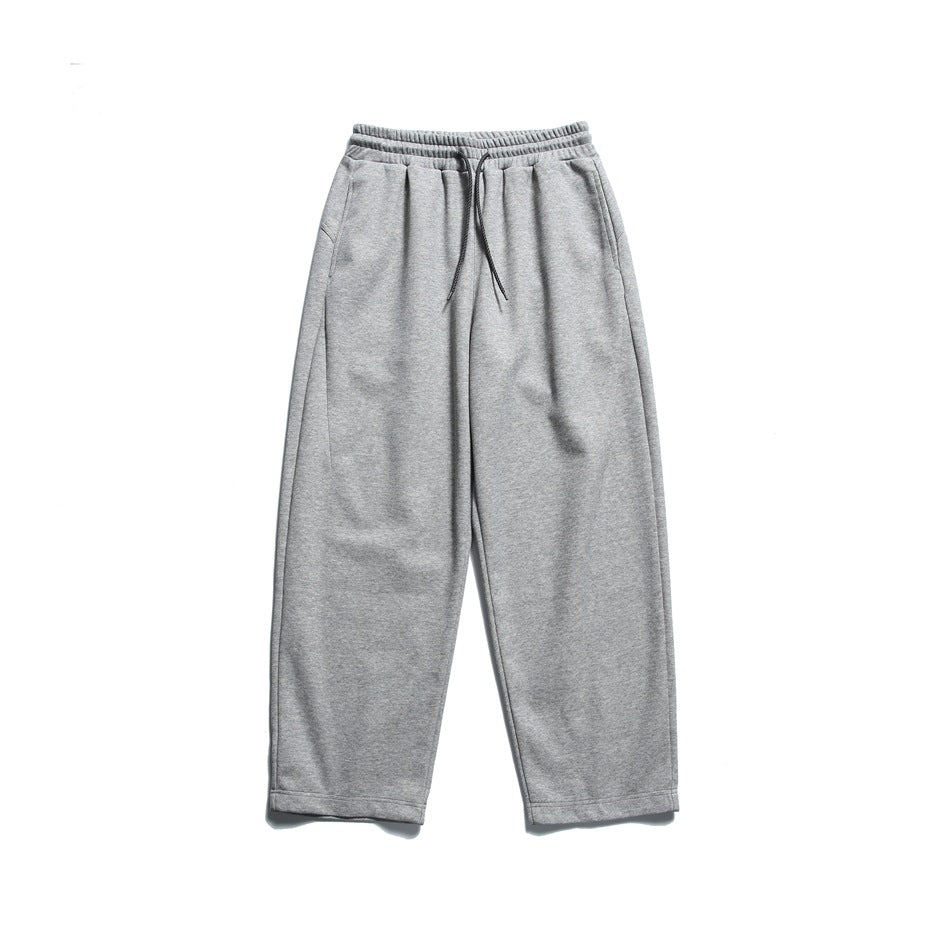 Heather gray drawstring sweatpants with wide straight legs, laid flat, front view