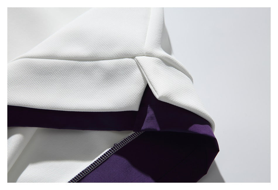 Close-up of a white garment opening with dark purple inner fabric and overlock stitching.