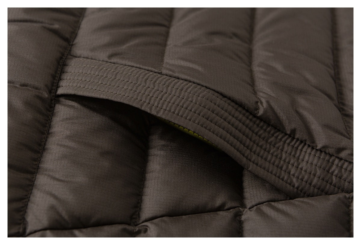 Close-up of brown quilted jacket panels and a curved, multi-row stitched seam.
