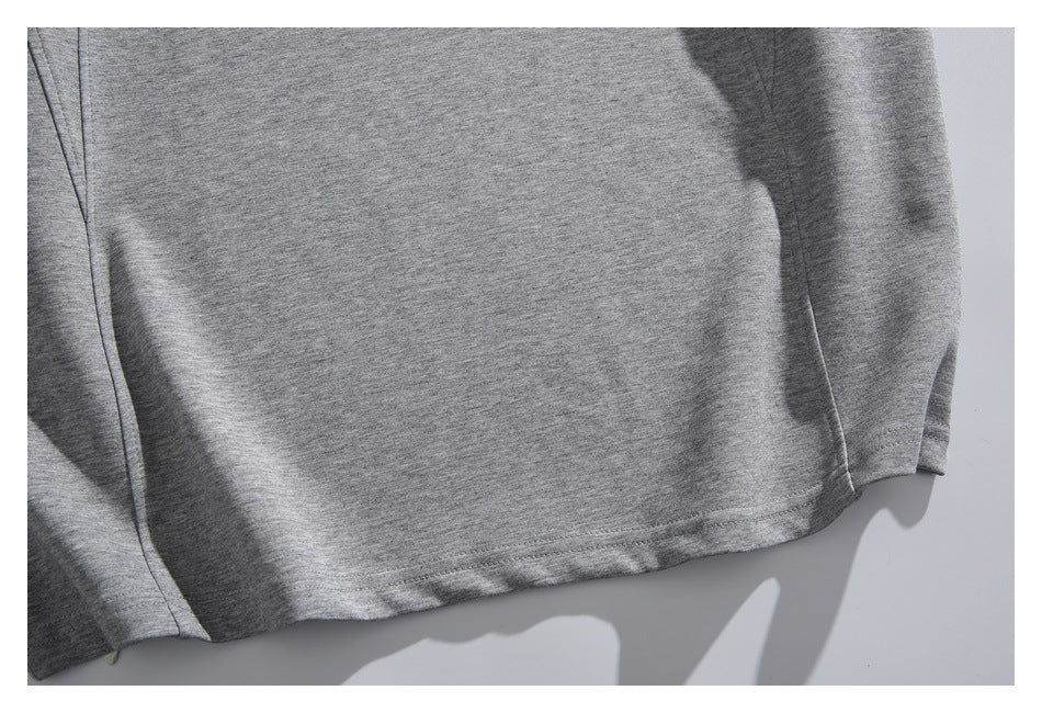 Close-up of the heather gray sweatshirt's lower hem, sleeve edge, and side seam.