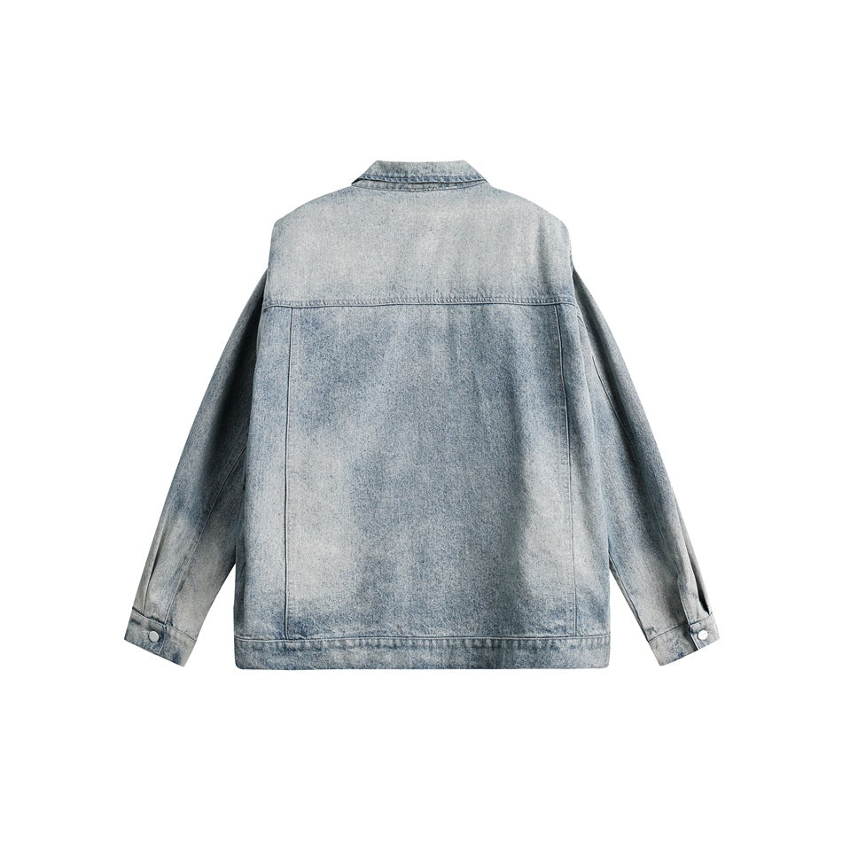 Back view of a light-wash denim jacket, showing a plain panel, shoulder yoke and buttoned cuffs.