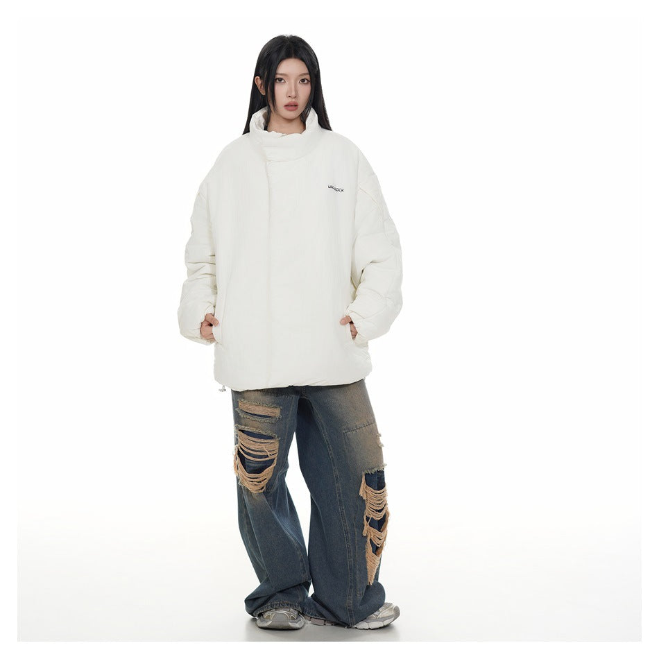 Model wearing an oversized off-white stand-collar puffer jacket with distressed wide-leg jeans, full-length view