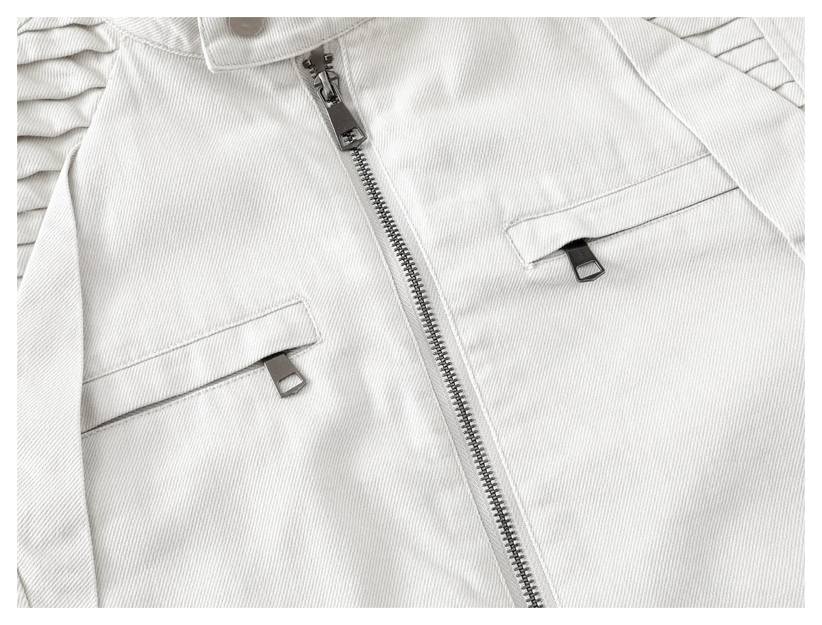 Close-up of an off-white jacket front with a metal zipper and two flap-covered pockets.