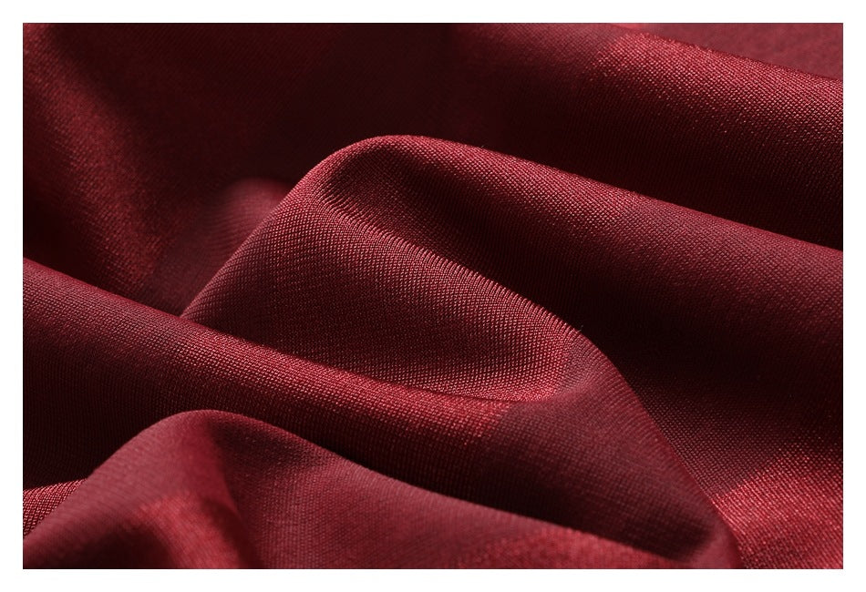 Extreme close-up of the burgundy fabric's textured surface and folds.