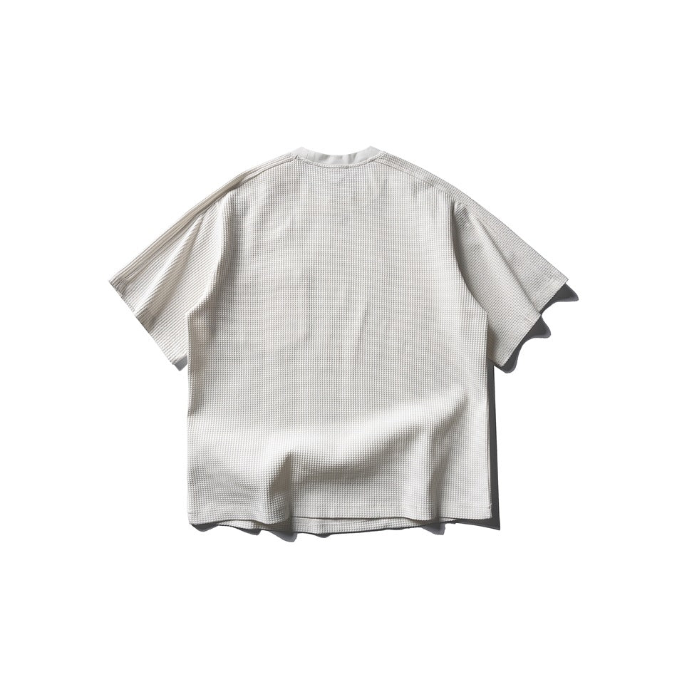 Back view of an ivory short-sleeve waffle-textured T-shirt.