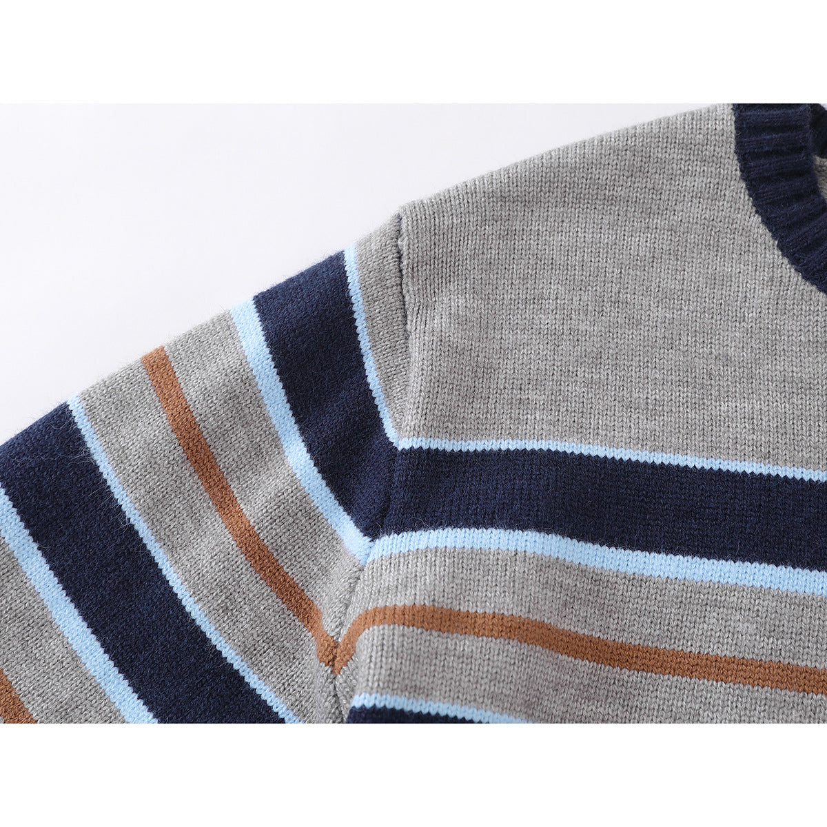 Close-up of a gray sweater sleeve and shoulder with navy, light blue, and rust stripes.