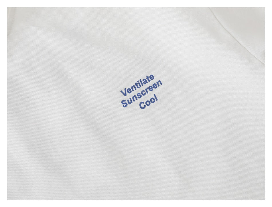 Close-up of white fabric with small blue “Ventilate Sunscreen Cool” print.