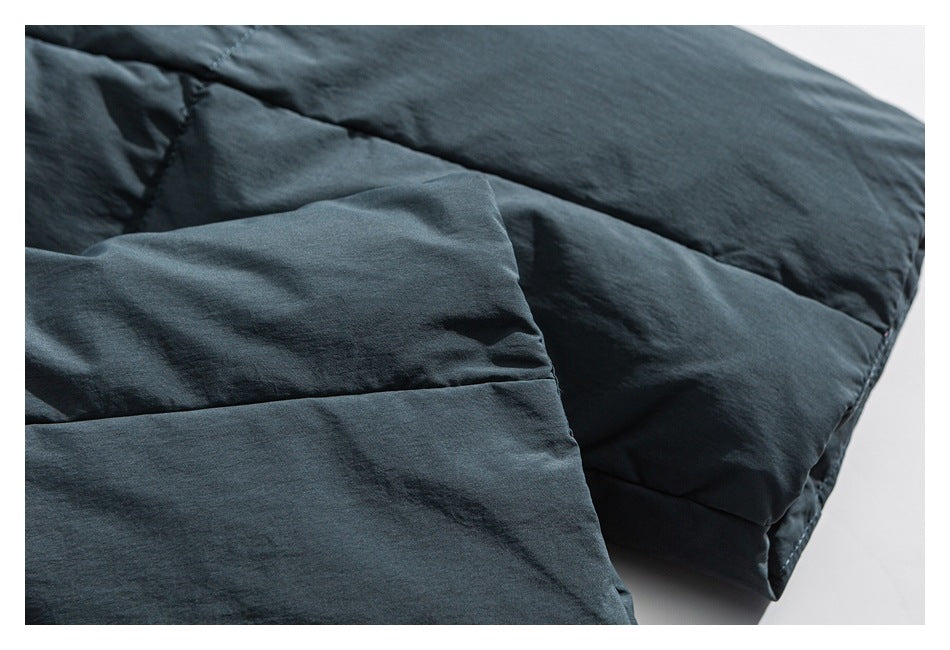 Close-up of the dark blue-gray jacket's padded, stitched panels.