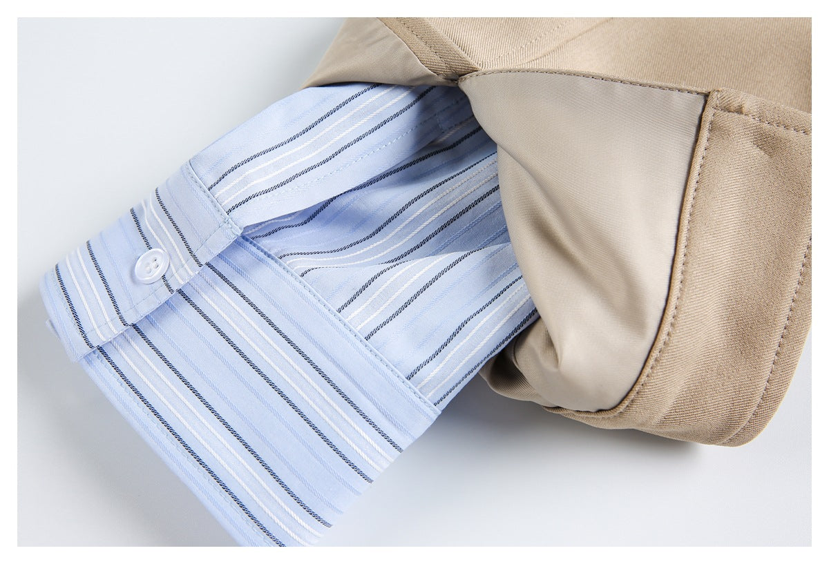 Beige garment folded back to reveal a light blue striped inner cuff with a small white button.