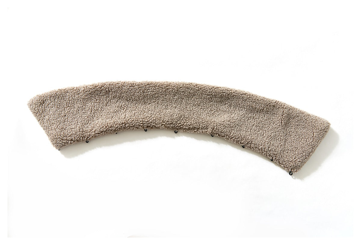 Detached curved beige fleece collar piece laid flat, with small black attachment loops along one edge.
