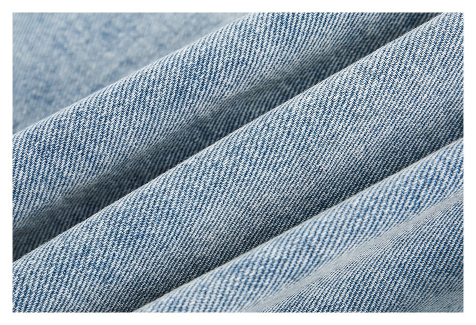 Macro view of the diagonal weave and texture of light-blue denim.