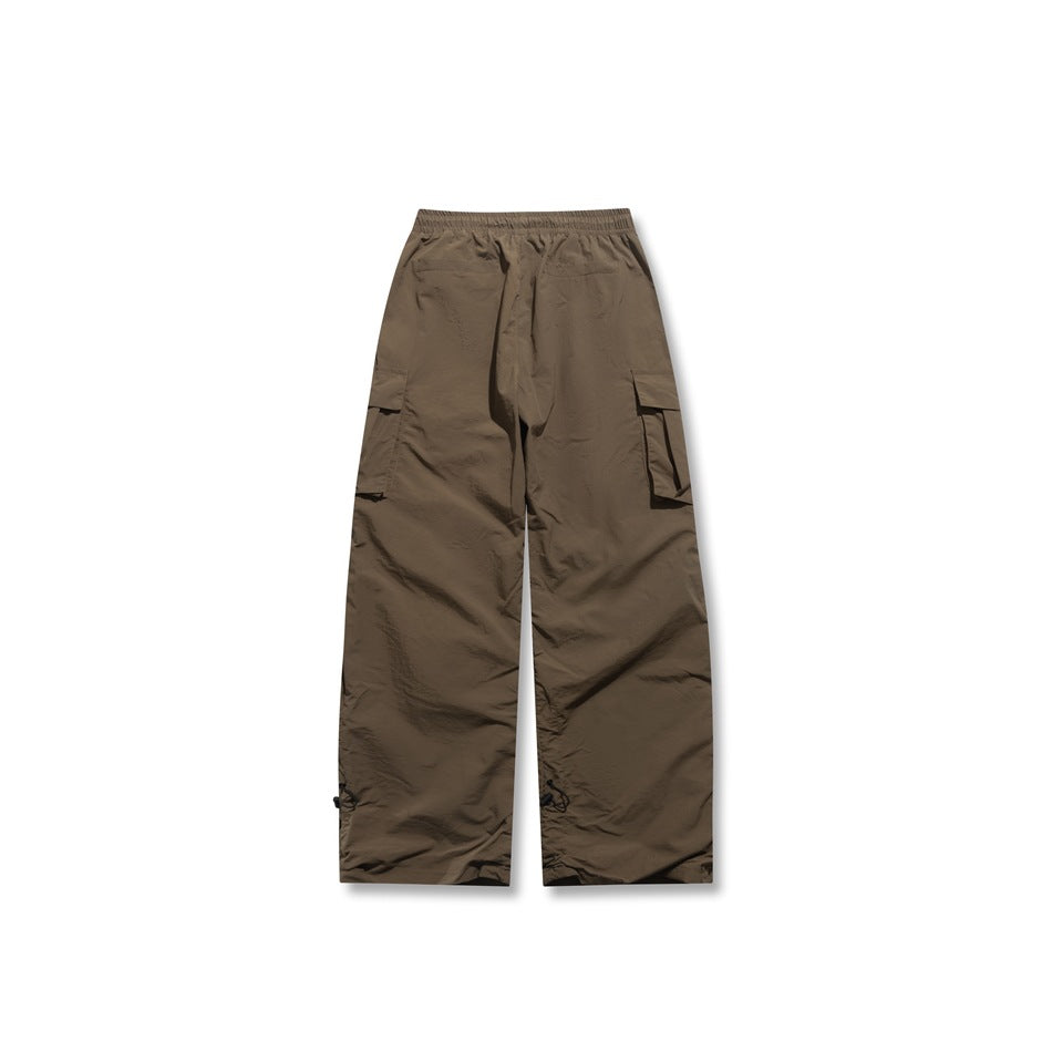 Brown wide-leg cargo pants flat back view showing elastic waistband, side cargo pockets and toggle hems
