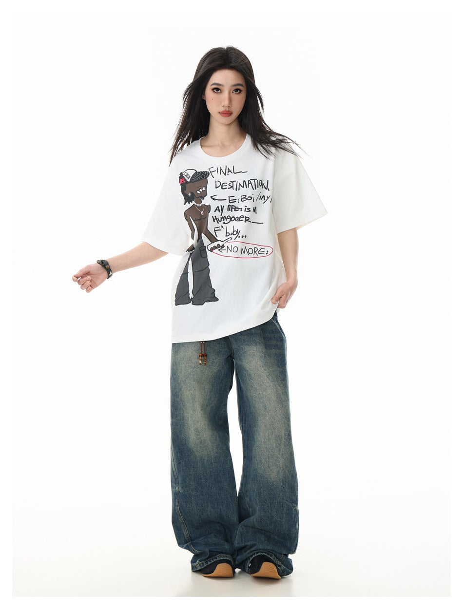 Model wearing the white graphic t-shirt with wide-leg faded blue jeans, front view