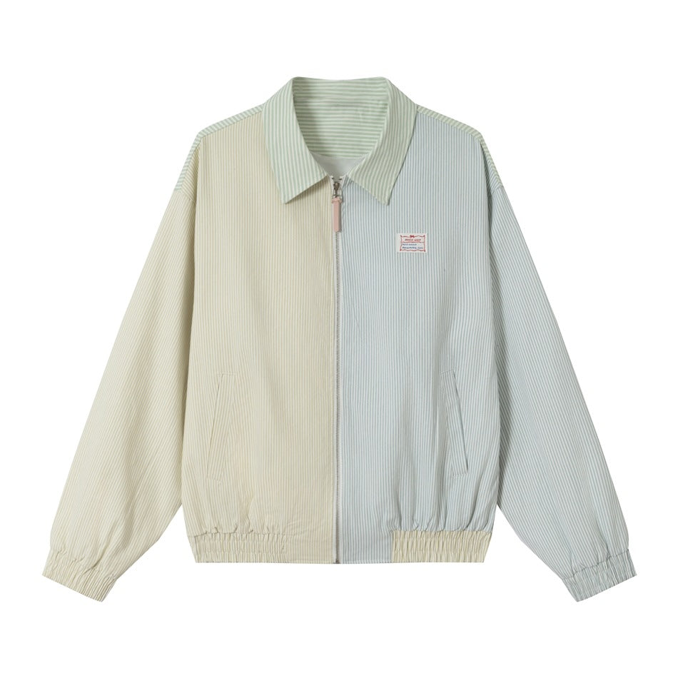 Zip-front striped jacket in pale yellow-green and light blue color blocks with pointed collar, flat lay