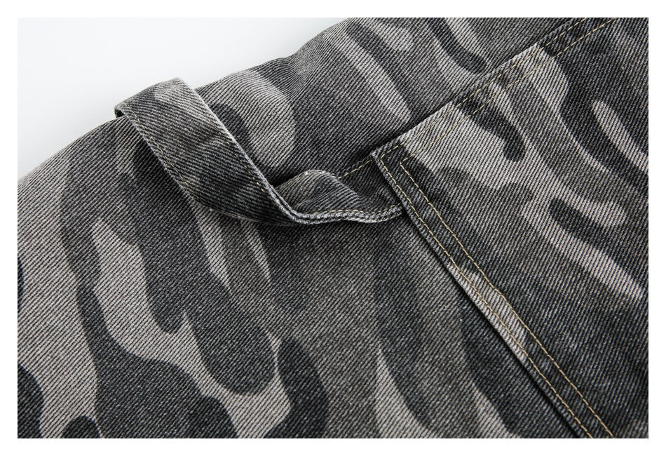 Close-up of a belt loop and pocket seam on gray camouflage denim pants.