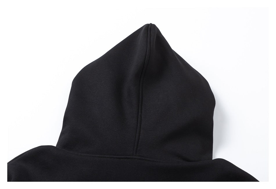 Close-up of a black hood showing its center seam and attached neckline.
