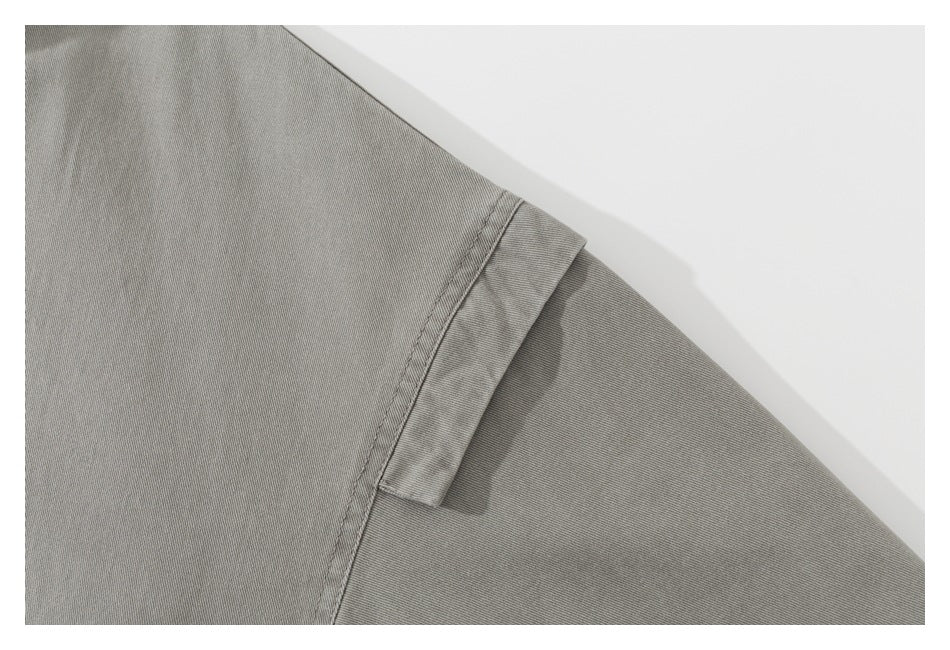 Close-up of the gray jacket's shoulder seam and sleeve panel.