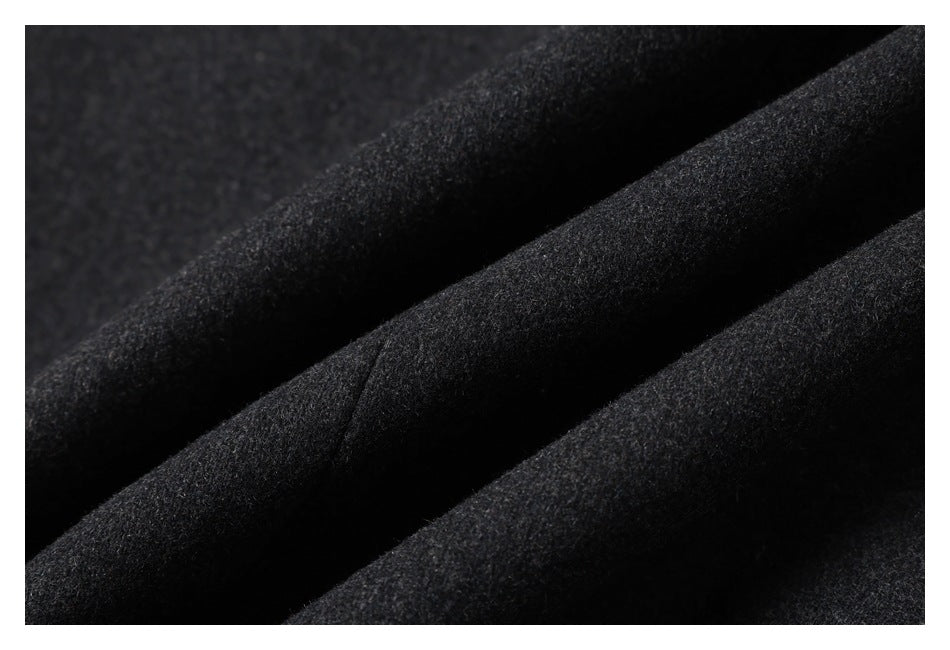 Close-up of dark charcoal fabric arranged in soft folds.