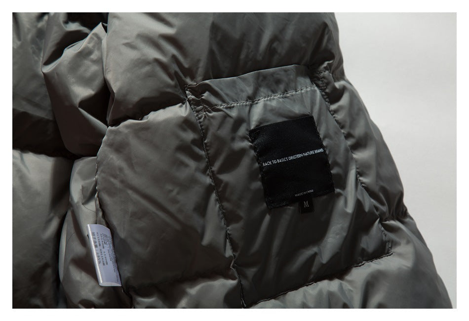 Close-up of the jacket’s gray quilted lining, sewn black brand label, and care tag.