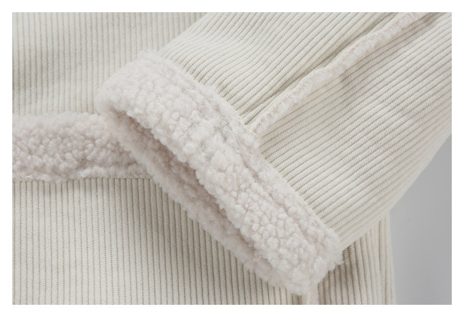 Close-up of an ivory ribbed sleeve cuff with thick fuzzy trim.