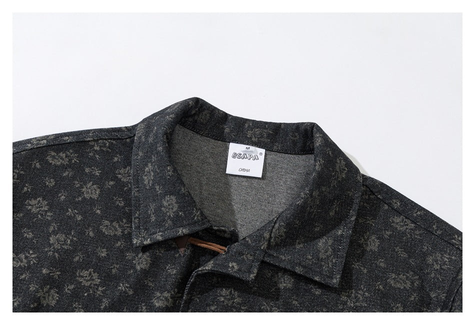 Close-up of a dark charcoal floral-patterned jacket collar and sewn neck label.