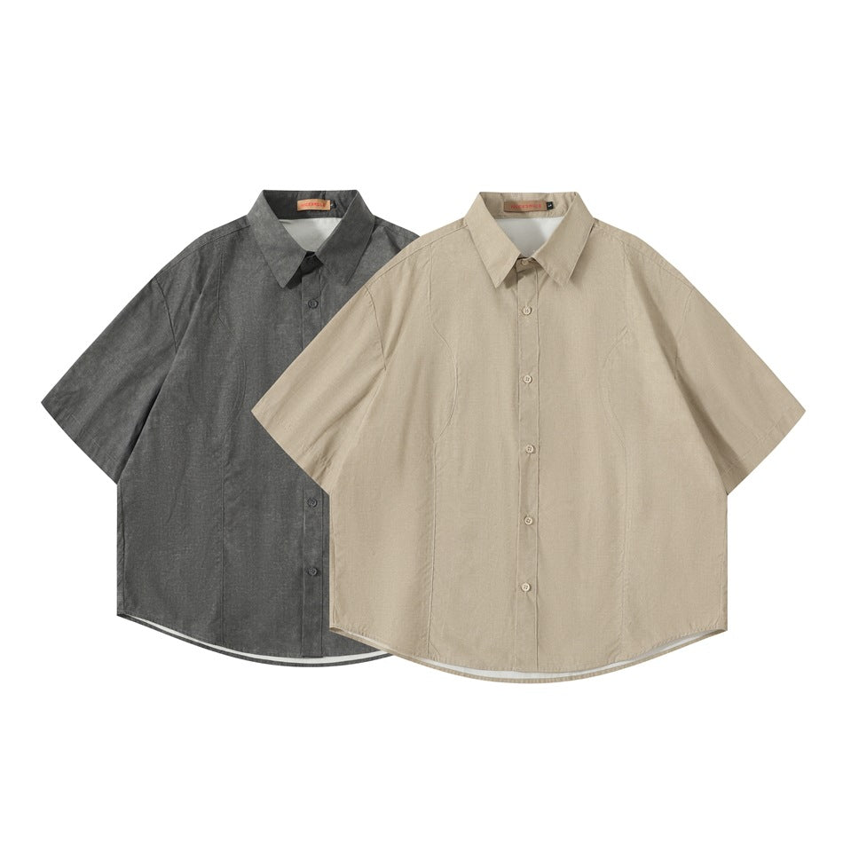 Two short-sleeve button-up shirts shown from the front in charcoal gray and beige.