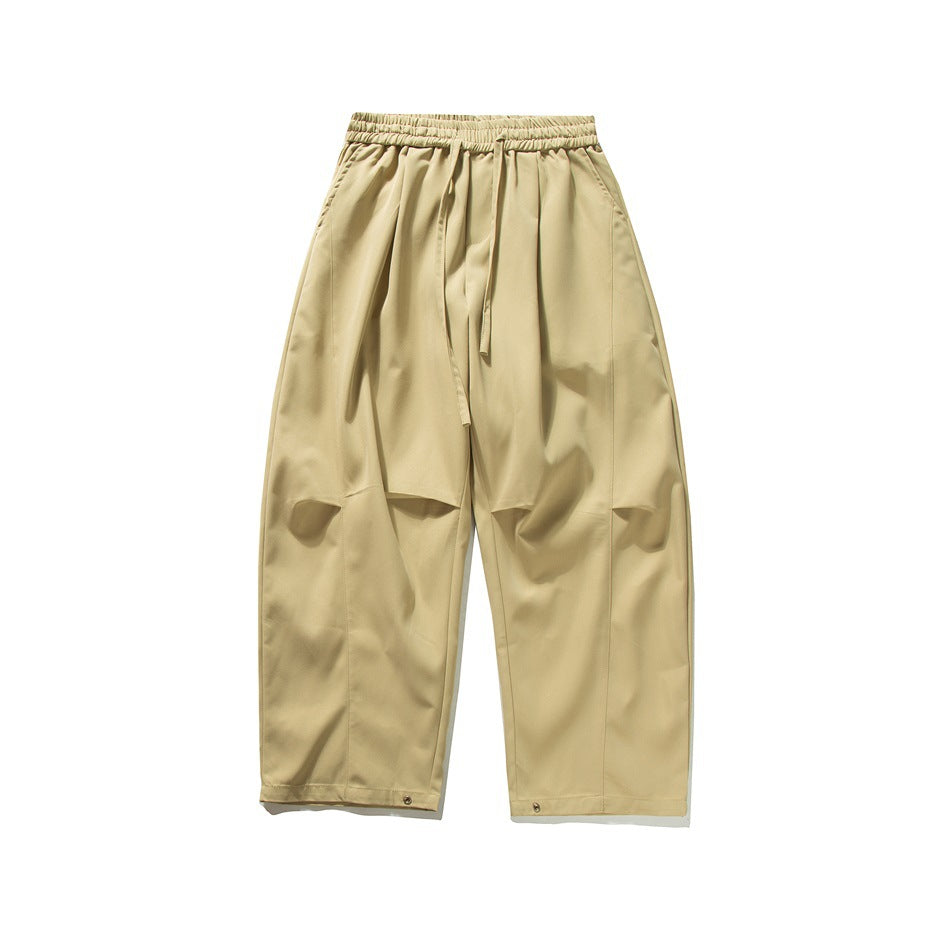 Khaki wide-leg drawstring pants, flat front view with knee folds and hem snaps