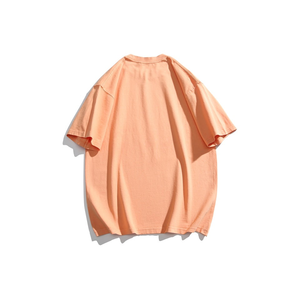 Back view of a plain oversized peach T-shirt with short sleeves, displayed against a white background.