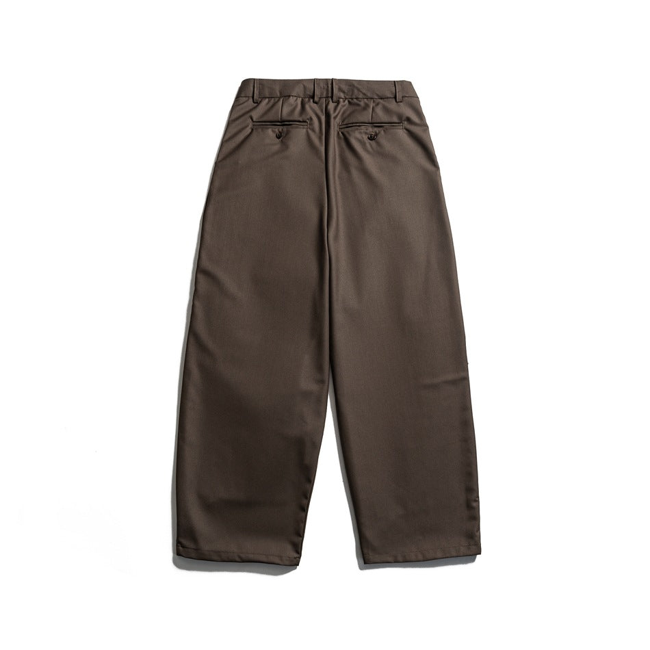 Back view of brown trousers with belt loops and two buttoned welt pockets.