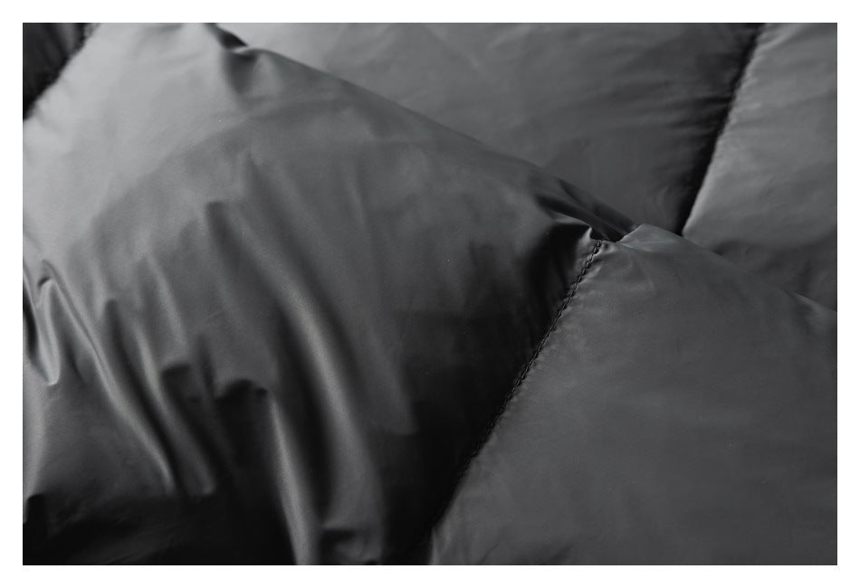 Close-up of black padded garment panels and a curved stitched seam.