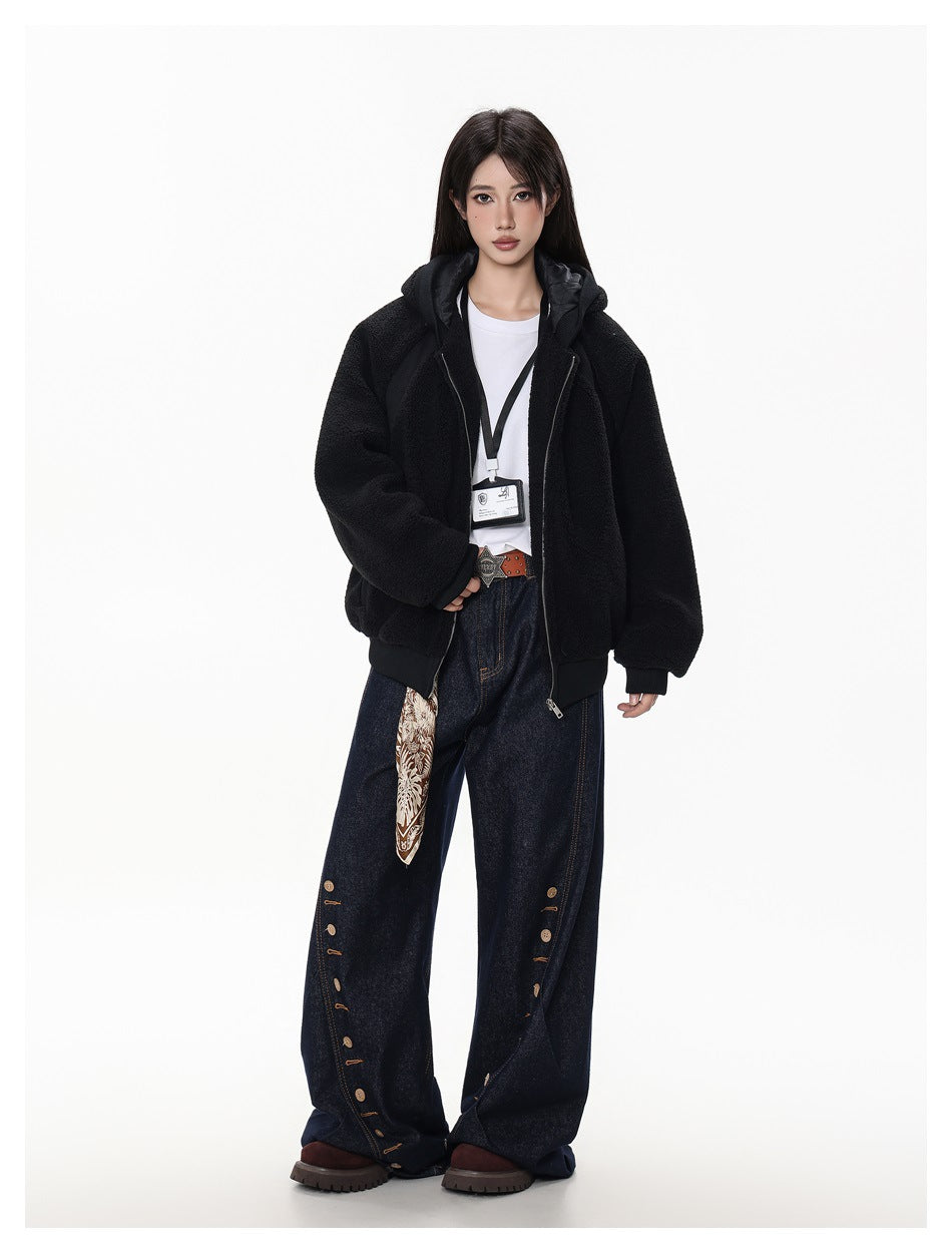Full-length model wearing an open black hooded jacket and wide-leg dark jeans with decorative buttons.