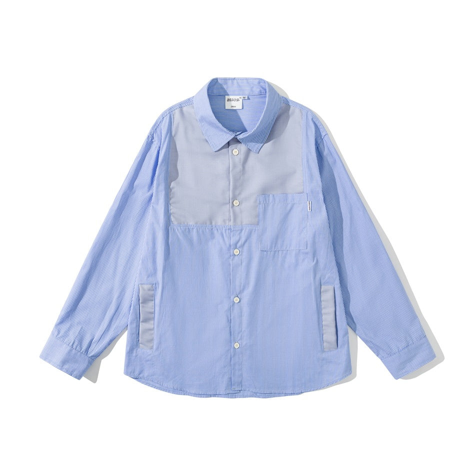 Flat lay front of a light blue pinstripe long-sleeve shirt with a gray-blue chest panel and patch pocket