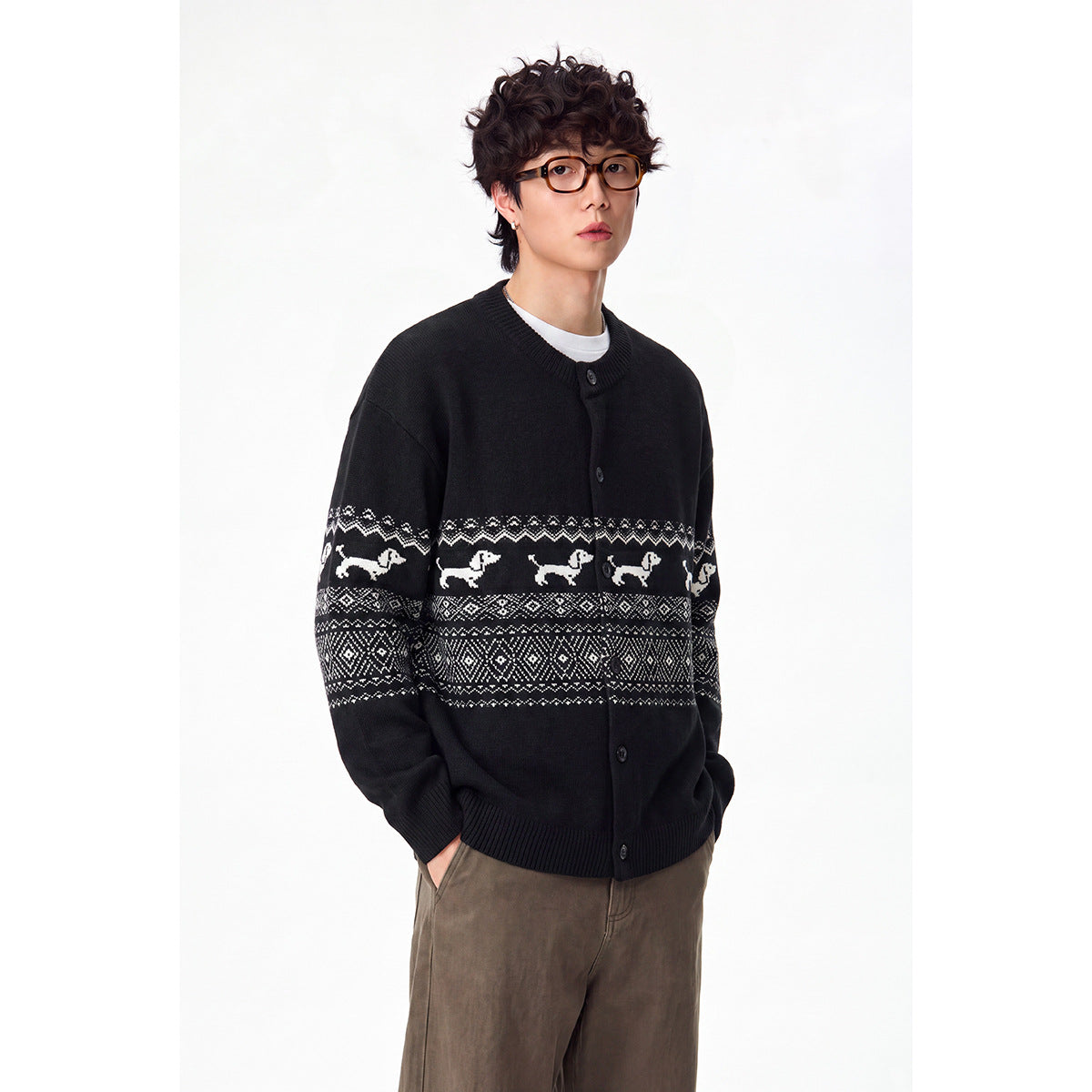 Model wearing a black button-front cardigan with white dog motifs and geometric bands across the chest and sleeves.