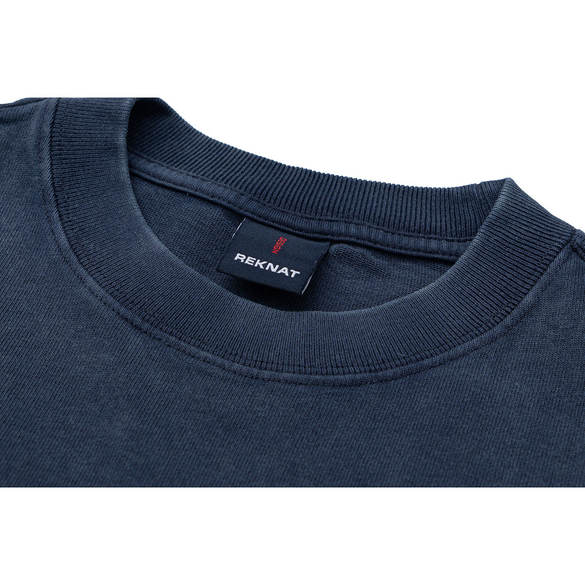 Close-up of a navy T-shirt's ribbed crew neck and sewn-in label.